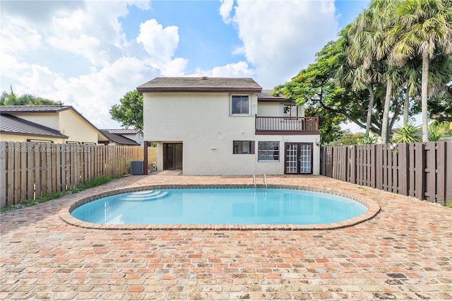 view of swimming pool with a fenced backyard, a patio, and central air condition unit