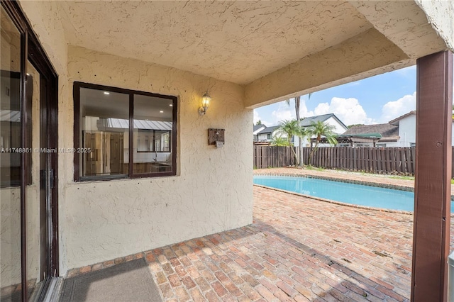 view of swimming pool featuring a patio and a fenced backyard