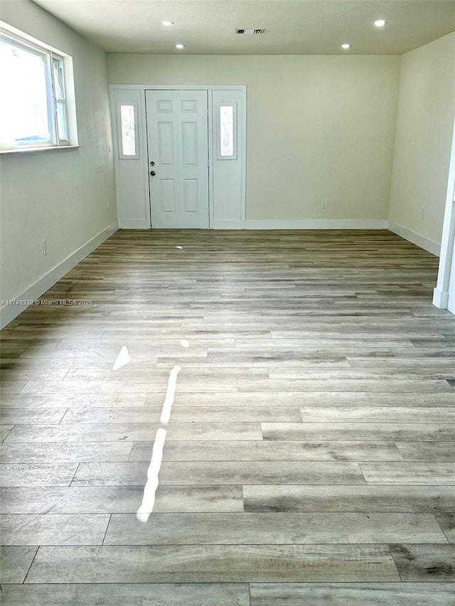 entrance foyer featuring baseboards, recessed lighting, and light wood-style floors