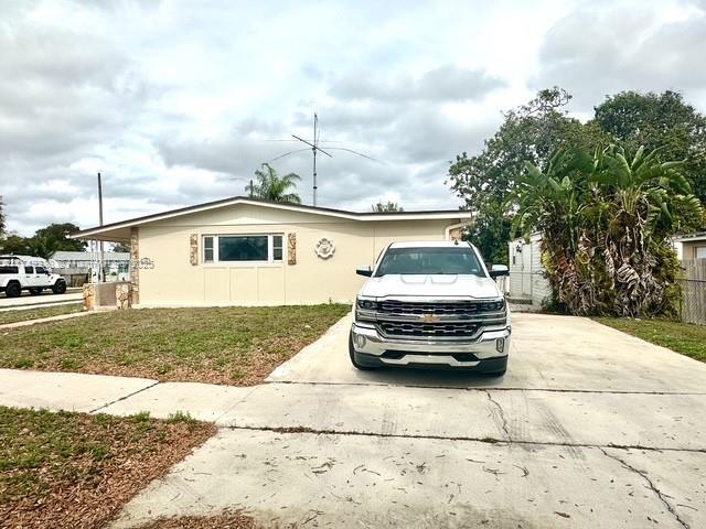 view of front of house featuring driveway and a front lawn