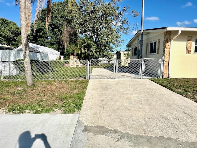 view of road featuring a gate, a gated entry, and concrete driveway