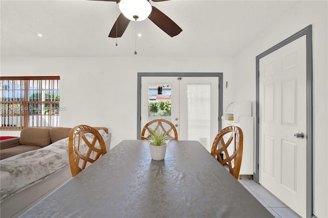 dining space featuring light tile patterned floors, french doors, and a ceiling fan