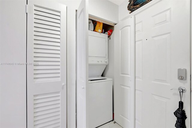 clothes washing area featuring laundry area and stacked washer and clothes dryer