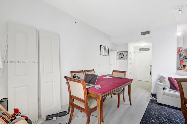 dining area featuring visible vents and wood finished floors