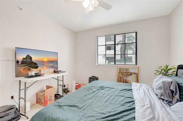 bedroom with a ceiling fan and carpet