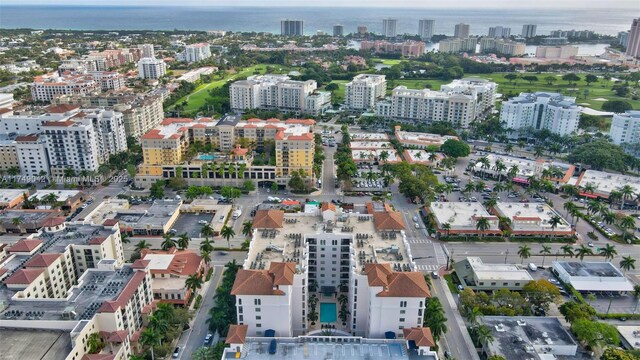 birds eye view of property featuring a water view and a city view