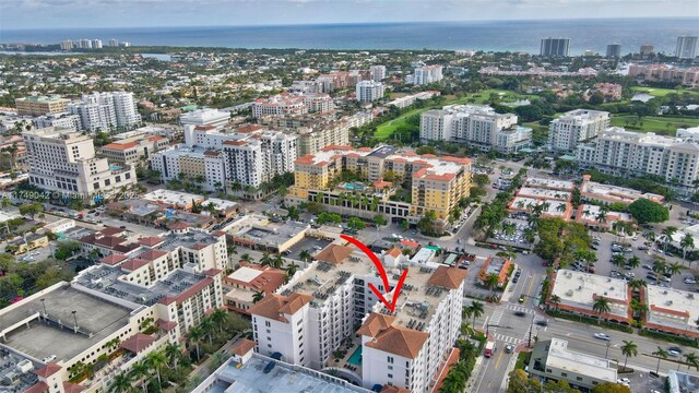 birds eye view of property with a water view and a view of city