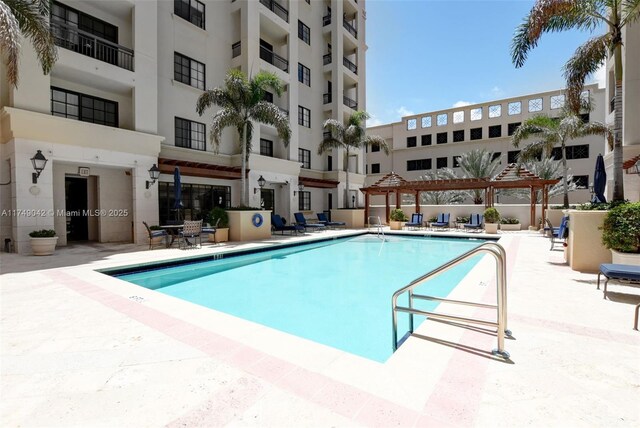 pool featuring a patio and a pergola