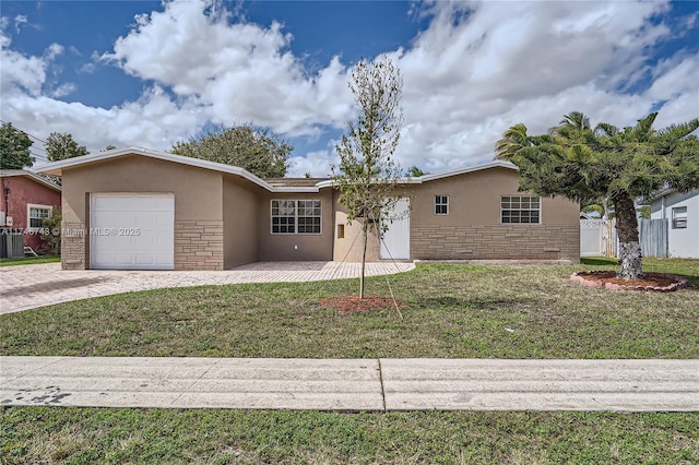 ranch-style home with decorative driveway, stucco siding, an attached garage, stone siding, and a front lawn