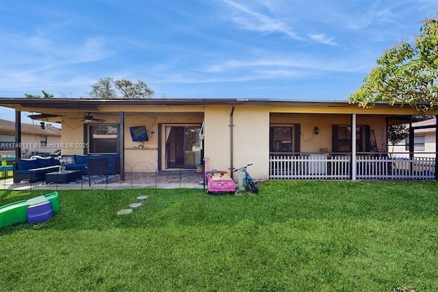 10927 NW 29th Ct, Sunrise, FL 33322 - back of house with an outdoor living space, a yard, fence, and stucco siding