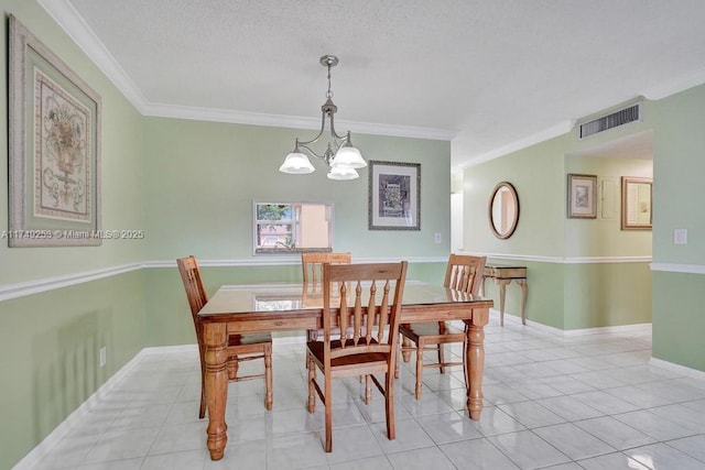 dining area with light tile patterned floors, baseboards, visible vents, ornamental molding, and a notable chandelier