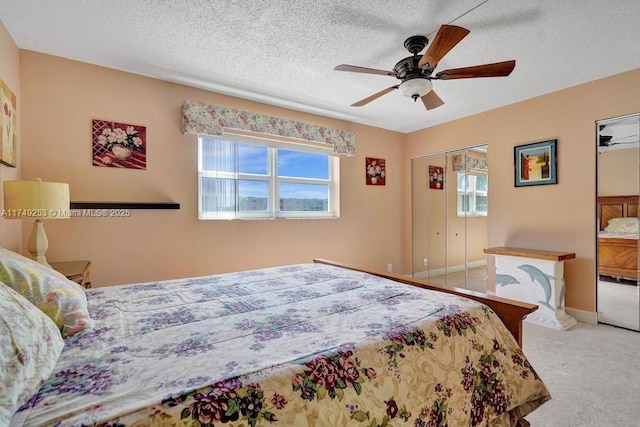 bedroom featuring ceiling fan, a textured ceiling, baseboards, and carpet flooring