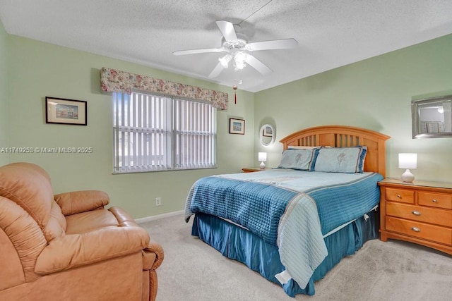 bedroom with a textured ceiling, baseboards, a ceiling fan, and light colored carpet