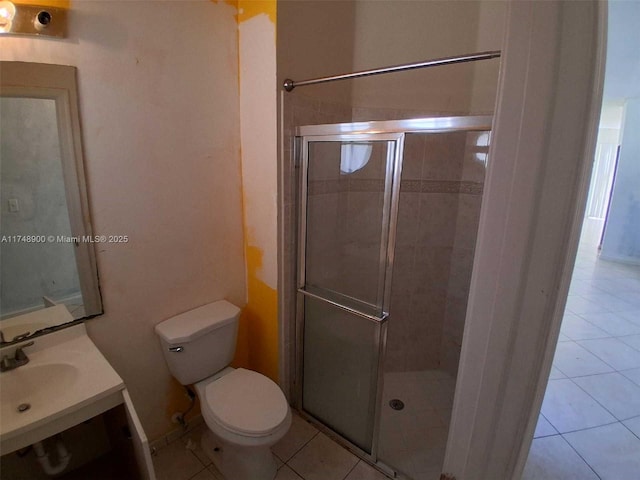 bathroom featuring a stall shower, vanity, toilet, and tile patterned floors