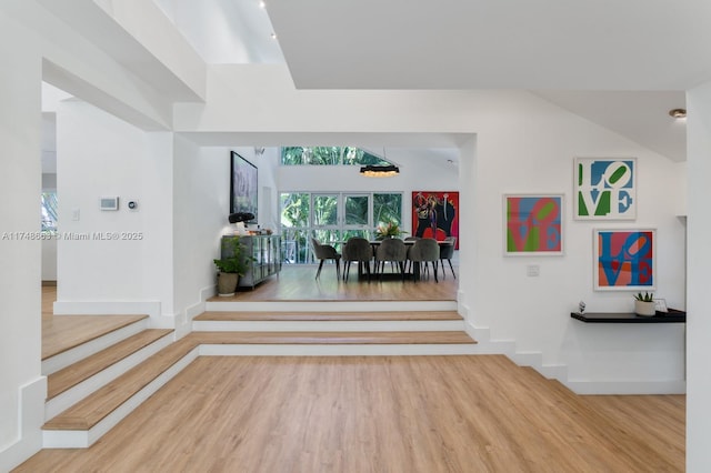 144 N Prospect Dr, Coral Gables, FL 33133 - entrance foyer featuring wood finished floors and a chandelier