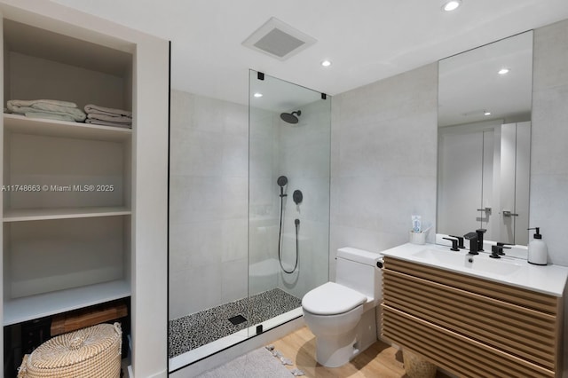 144 N Prospect Dr, Coral Gables, FL 33133 - full bathroom with walk in shower, vanity, wood finished floors, recessed lighting, and tile walls