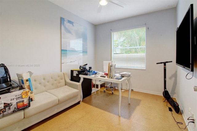 home office featuring ceiling fan, baseboards, and tile patterned floors