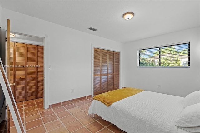 bedroom featuring light tile patterned floors, a closet, and visible vents