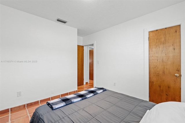 tiled bedroom with visible vents