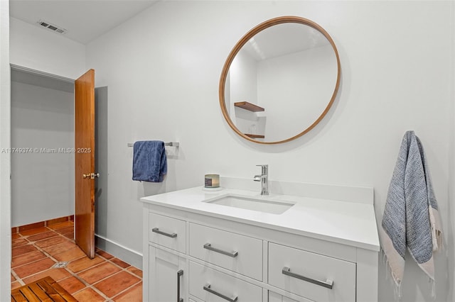 bathroom featuring baseboards, vanity, visible vents, and tile patterned floors