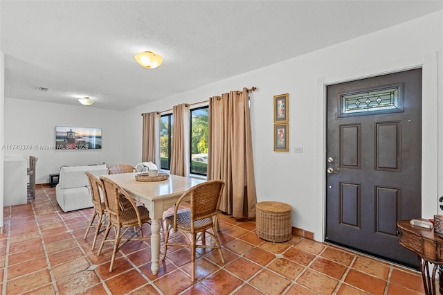 dining room featuring visible vents and a textured ceiling