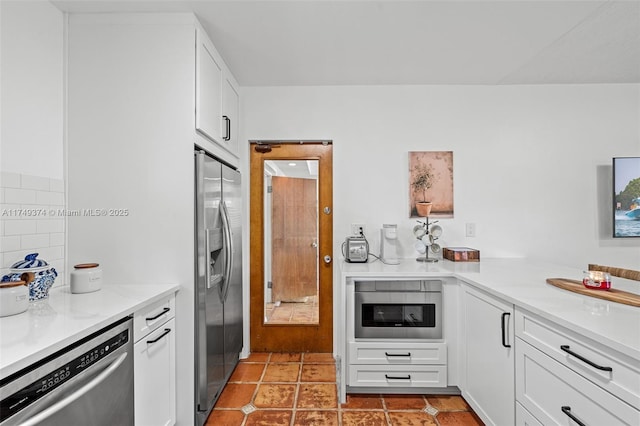 kitchen featuring white cabinetry, stainless steel appliances, light countertops, and light tile patterned flooring