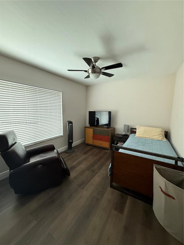 bedroom with ceiling fan, baseboards, and dark wood-style flooring