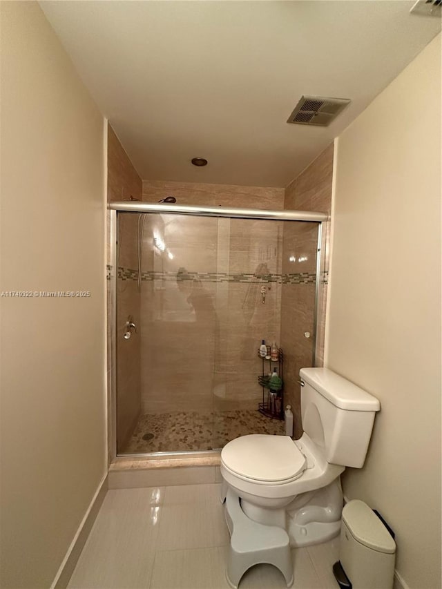 full bathroom featuring a stall shower, visible vents, and toilet