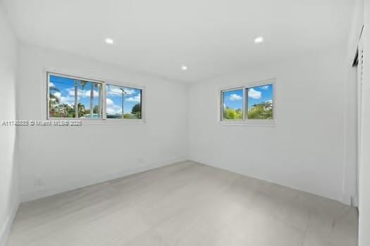 empty room with recessed lighting and a healthy amount of sunlight