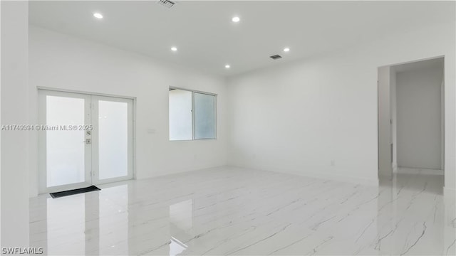 spare room featuring marble finish floor, french doors, visible vents, and recessed lighting