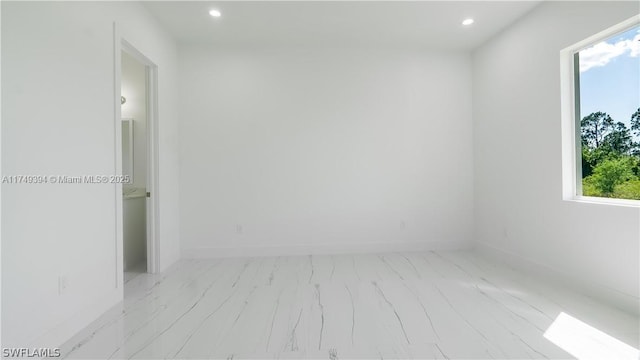 1123 Darling St, Lehigh Acres, FL 33974 - spare room featuring baseboards and recessed lighting