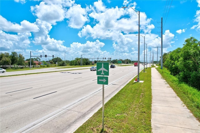 1123 Darling St, Lehigh Acres, FL 33974 - view of road with traffic lights, traffic signs, sidewalks, and street lights