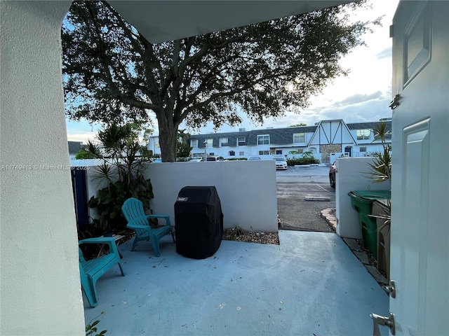 view of patio featuring fence and a residential view