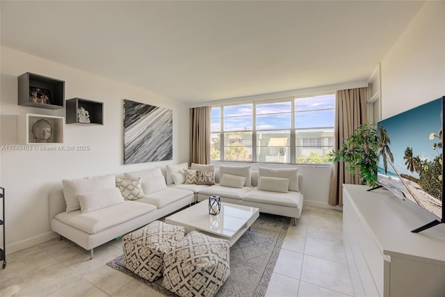 living room featuring light tile patterned flooring and baseboards