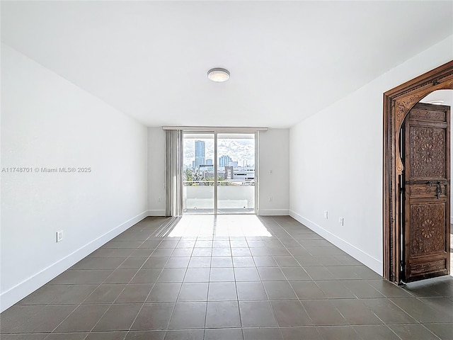 465 Ocean Dr Unit 701, Miami Beach, FL 33139 - unfurnished room with dark tile patterned floors and baseboards
