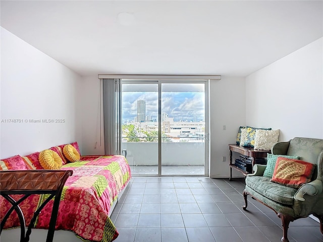 tiled bedroom with access to outside and a city view