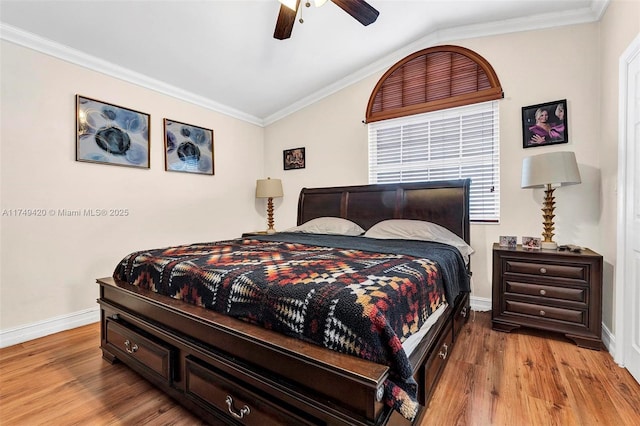 bedroom with crown molding, lofted ceiling, ceiling fan, light wood-type flooring, and baseboards