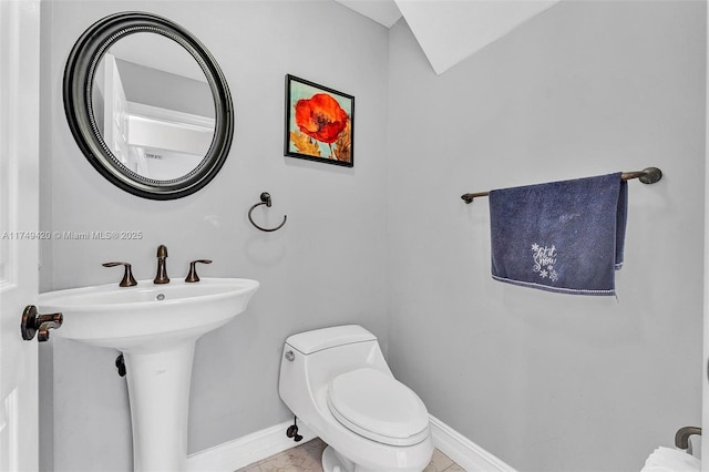 bathroom featuring toilet and baseboards