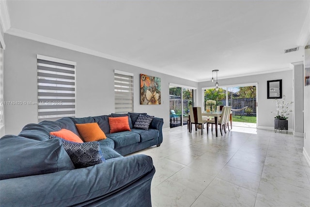 living room with baseboards, visible vents, and crown molding