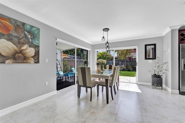 dining space featuring baseboards, marble finish floor, and crown molding