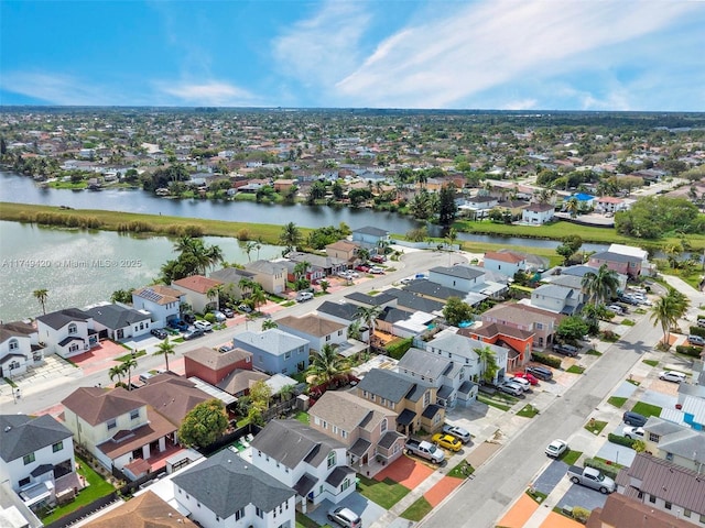 drone / aerial view featuring a water view and a residential view