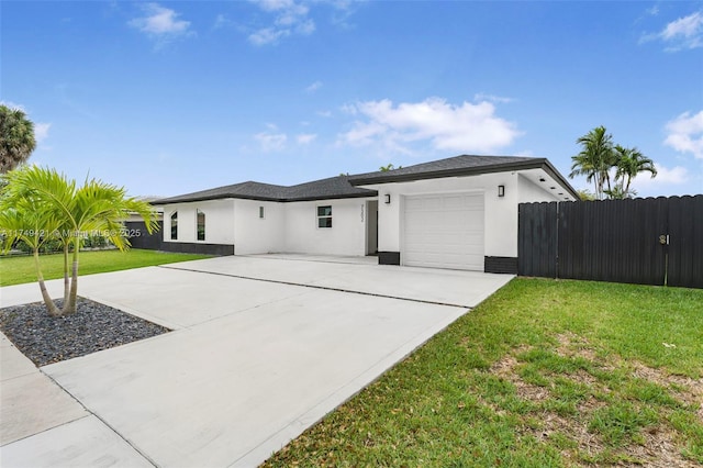 view of front of house with concrete driveway, a front yard, and stucco siding