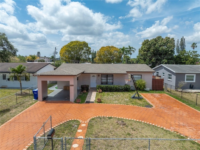 1820 N 27th Ave, Hollywood, FL 33020 - ranch-style house with driveway, a fenced front yard, and an attached carport