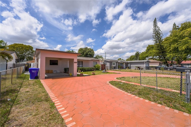 1820 N 27th Ave, Hollywood, FL 33020 - back of property featuring a yard, decorative driveway, stucco siding, and fence