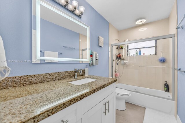 1820 N 27th Ave, Hollywood, FL 33020 - bathroom featuring toilet, shower / bath combination with glass door, tile patterned floors, and vanity