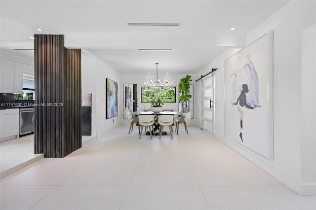 dining room with a barn door, a notable chandelier, visible vents, and light tile patterned floors
