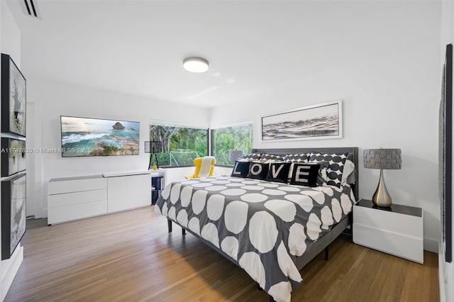 bedroom with visible vents and wood finished floors