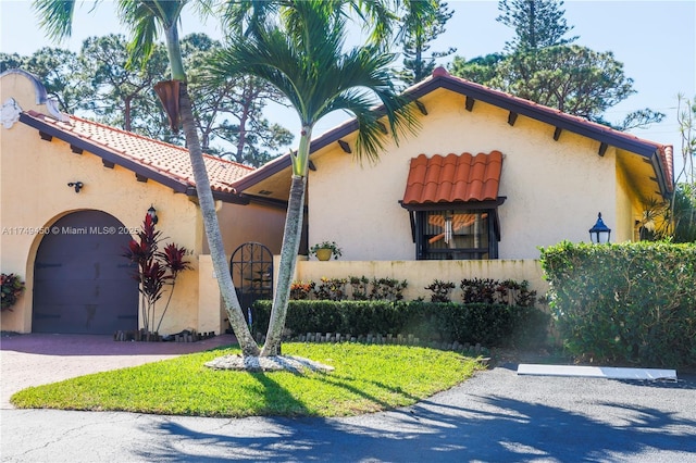 mediterranean / spanish house featuring stucco siding and a tile roof