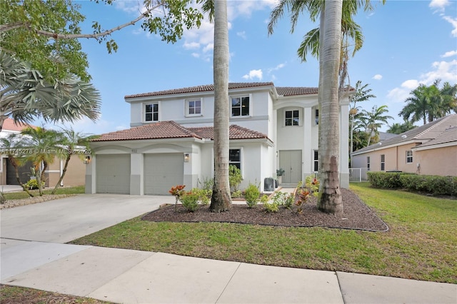 mediterranean / spanish house with driveway, a tile roof, an attached garage, a front lawn, and stucco siding