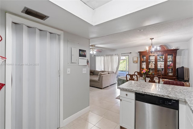 kitchen with light stone counters, visible vents, white cabinetry, open floor plan, and dishwasher